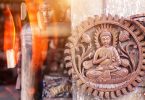 buddha brown wooden wall decor hanging on gray surface