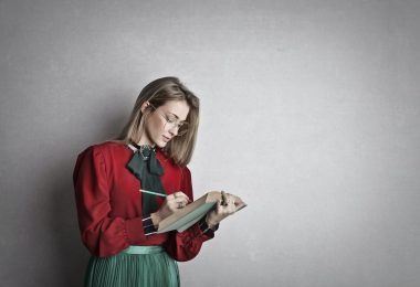 smart adult female student reading book in studio