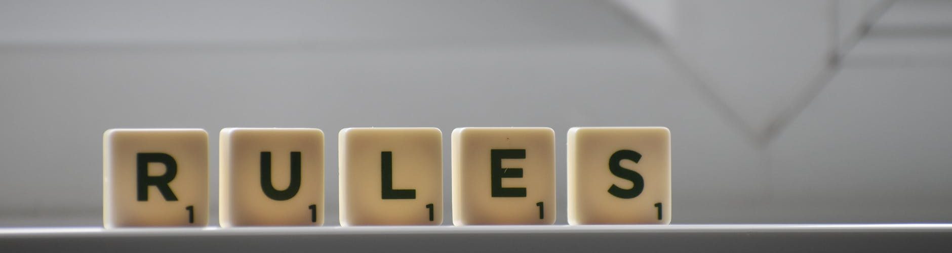 similar cubes with rules inscription on windowsill in building