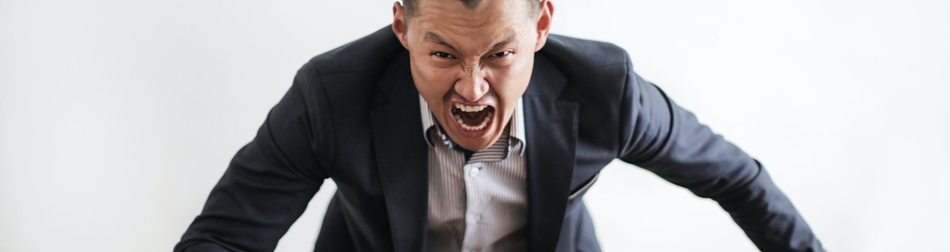 mad formal executive man yelling at camera