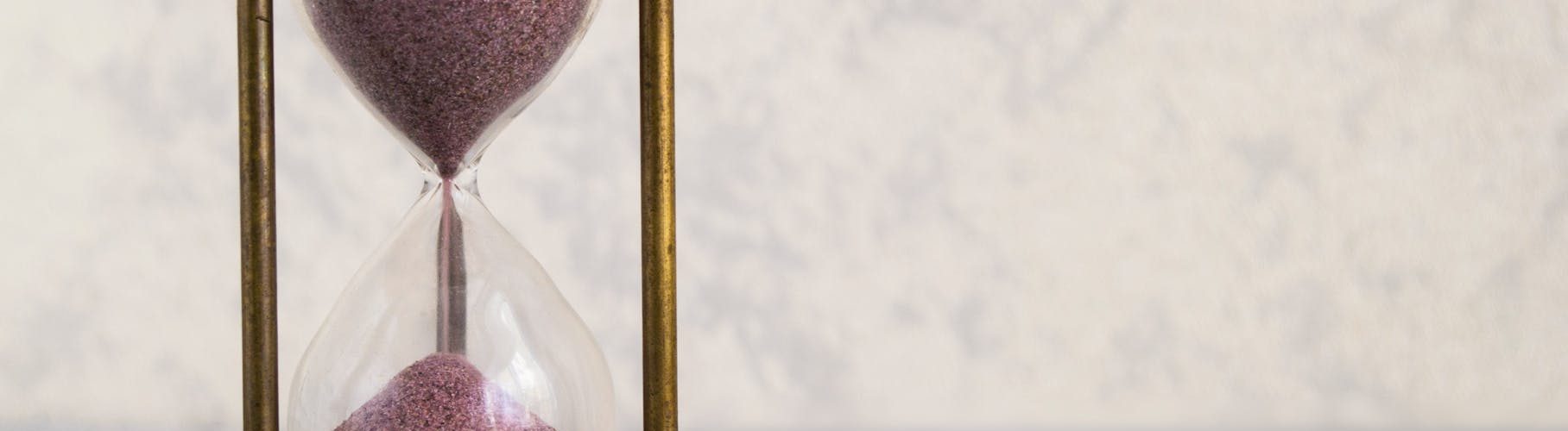 clear hour glass on golden frame