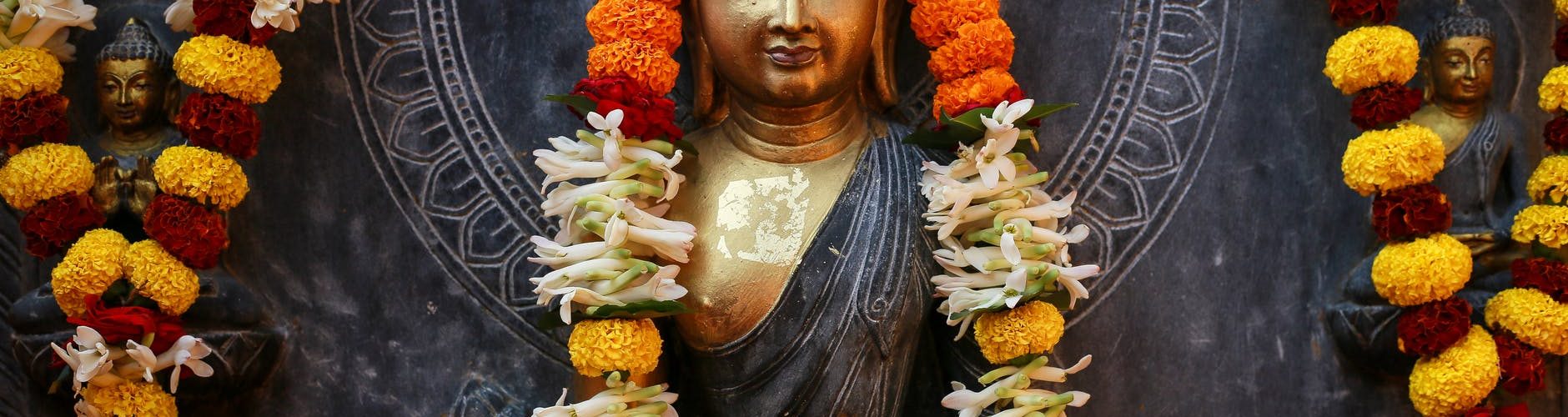 buddha surrounded with flowers