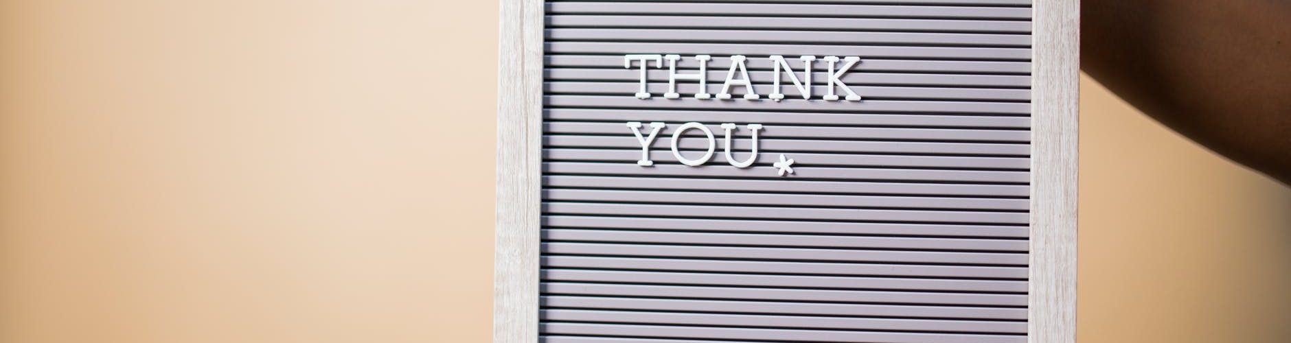 person holding gray and white i am a love you printed board