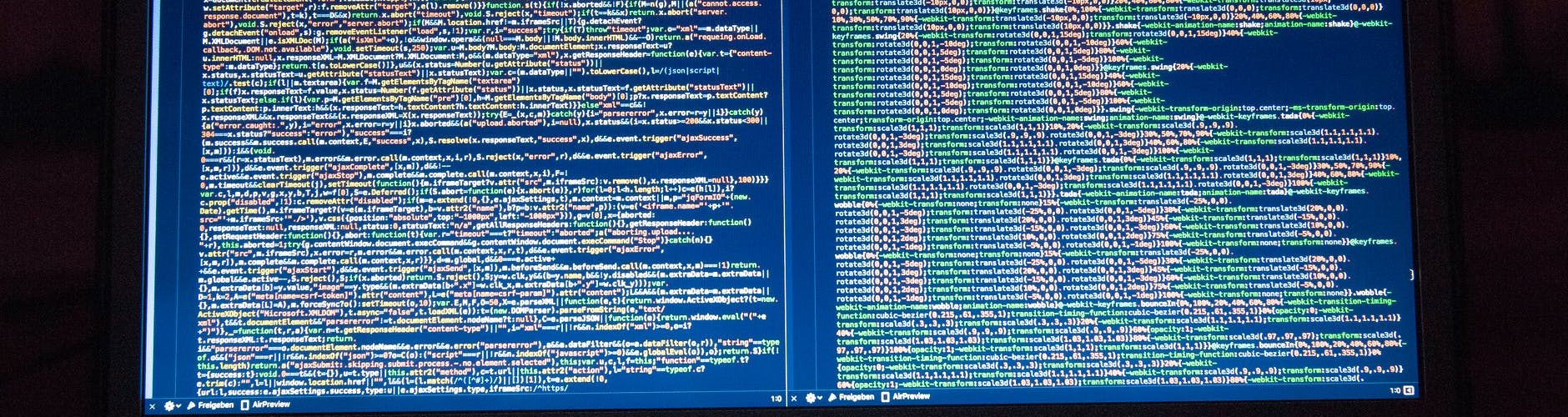 black laptop computer turned on showing computer codes