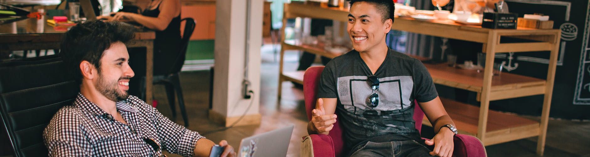 photograph of men having conversation seating on chair