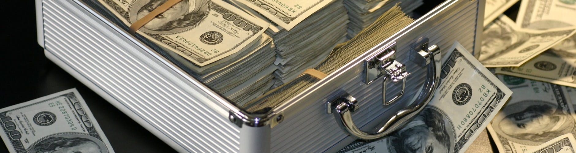 grey metal case of hundred dollar bills