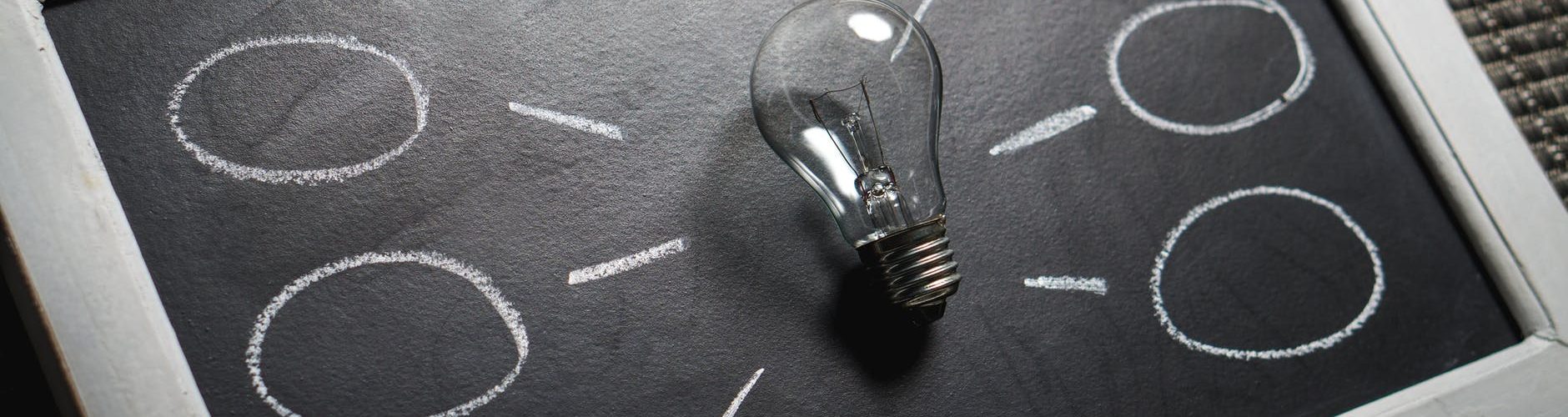 clear light bulb on black surface