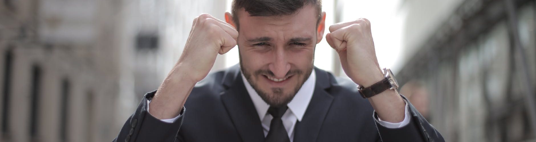 man in black suit achieved an accomplishment