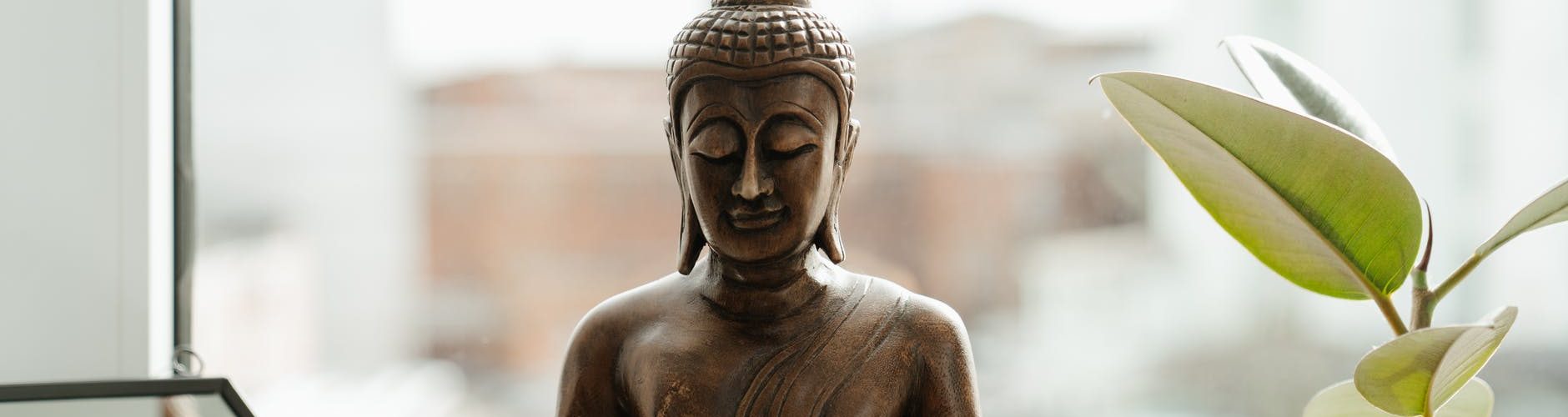 gold buddha statue on table