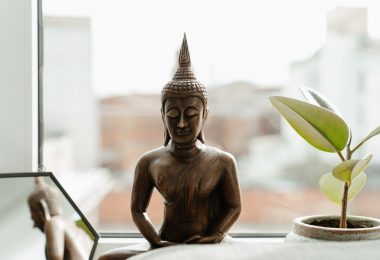 gold buddha statue on table