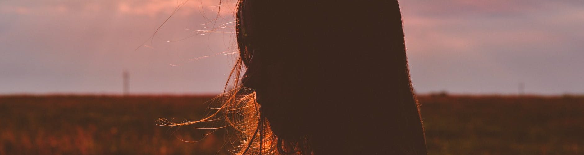 woman s silhouette photo during sunset