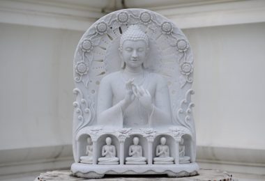 a sculpture of white marble gautam buddha