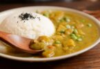 cooked rice and curry food served on white plate
