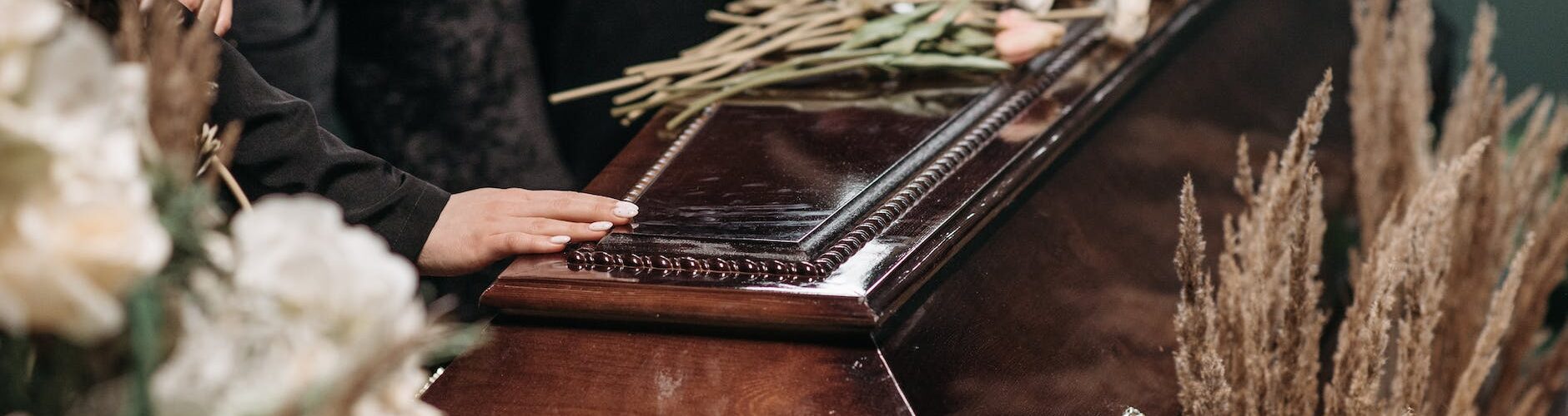 a person holding a wooden coffin
