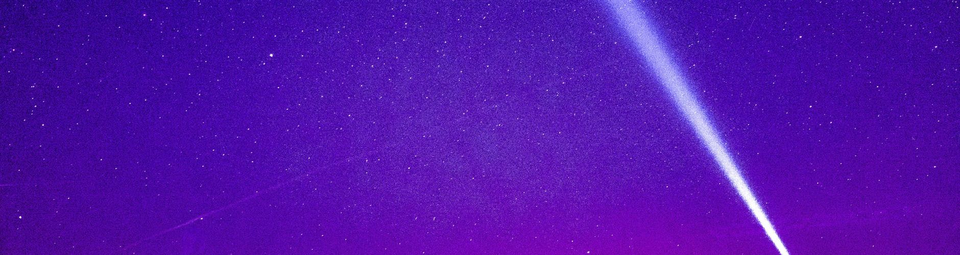 silhouette of person under blue and purple sky