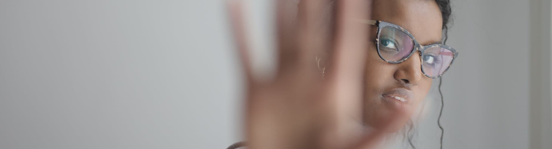 ethnic woman doing stop gesture with palm at camera