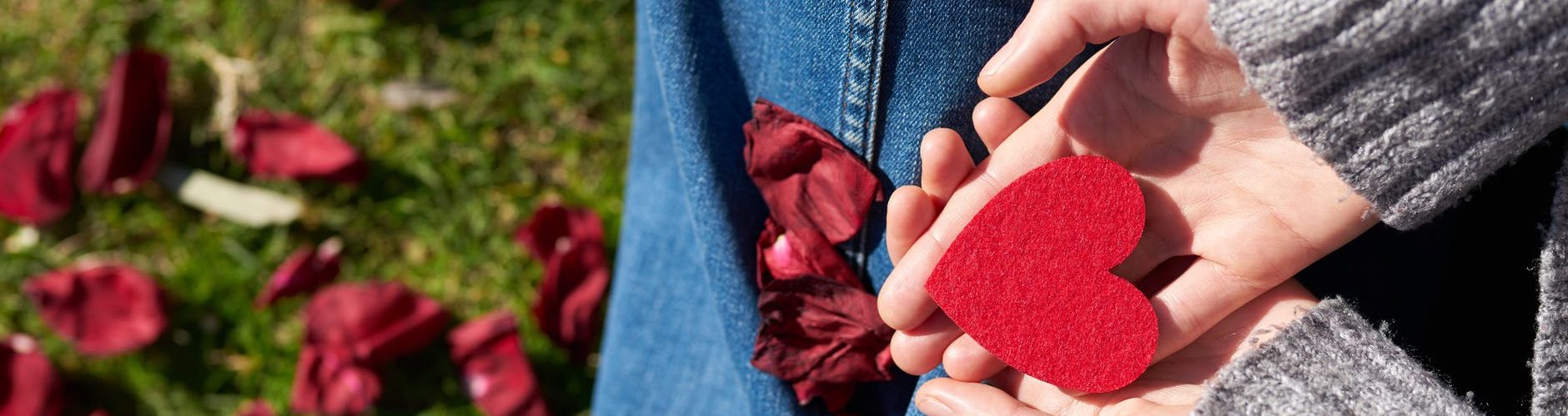 person holding heart shaped cut out