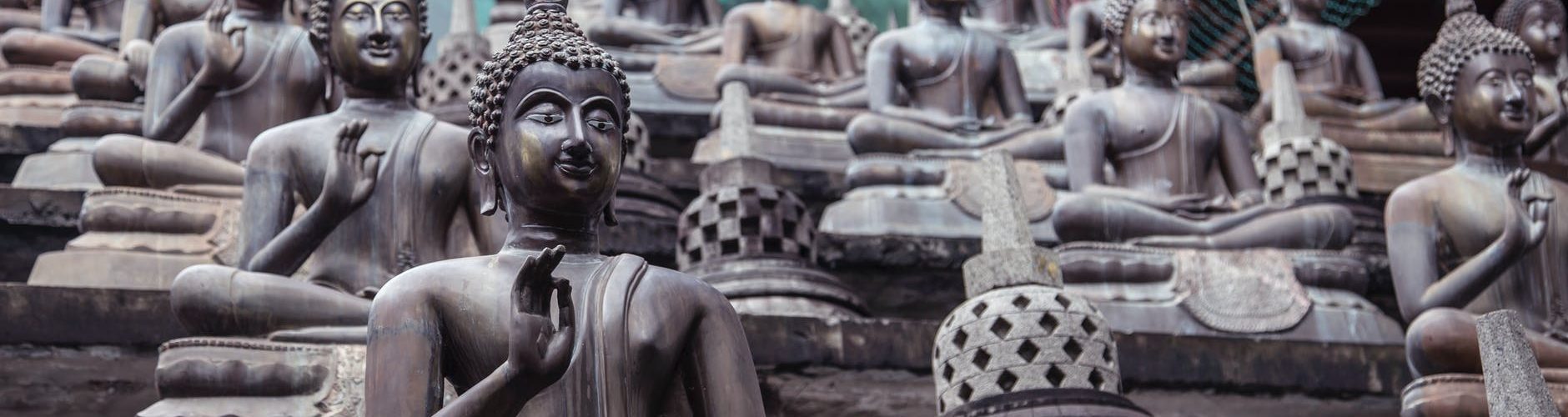 statues of buddha on stone stairs in oriental park