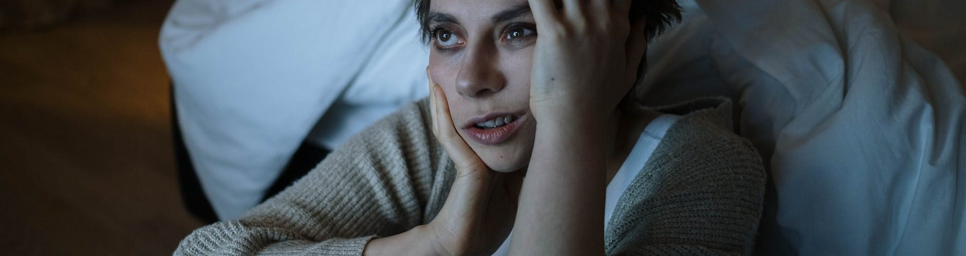 photograph of a woman touching her face