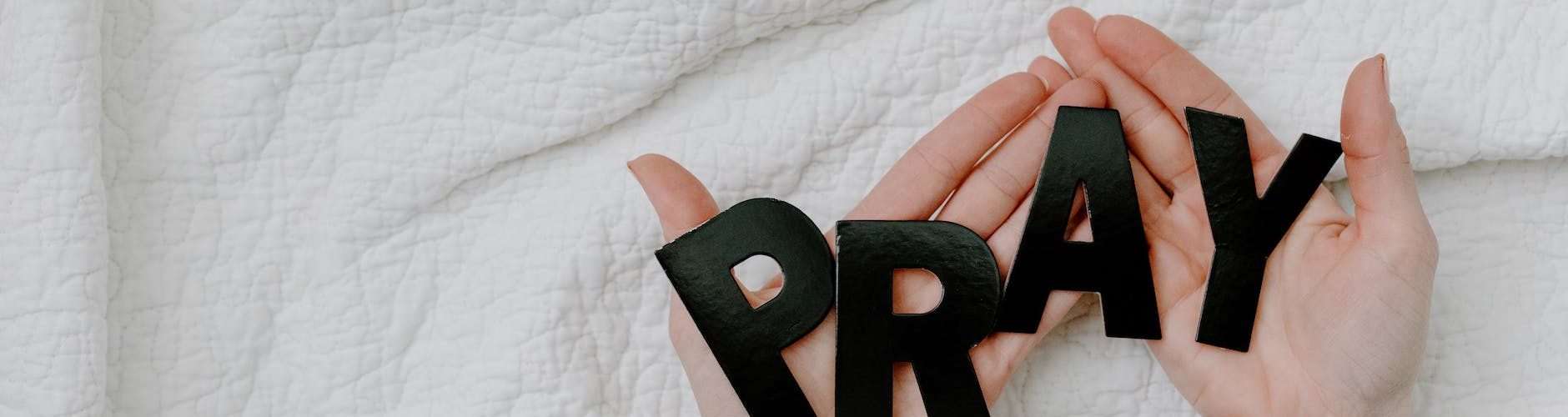 a person holding a black letters