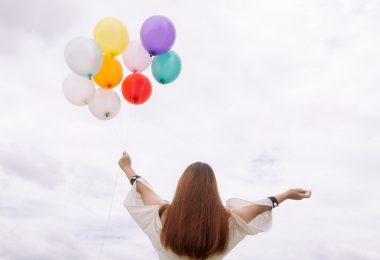 worm s eye view of woman holding balloons