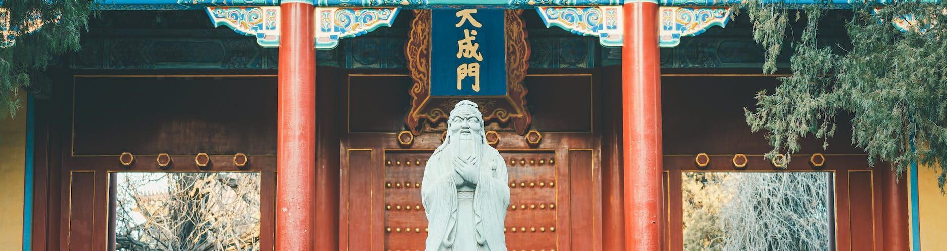 gray concrete statue near the wooden door
