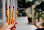 person holding pencils