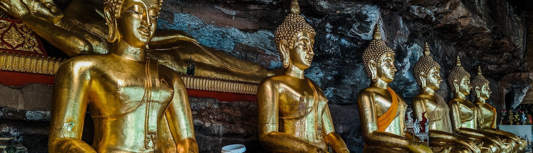 gautama buddha statuettes inside brown and white room