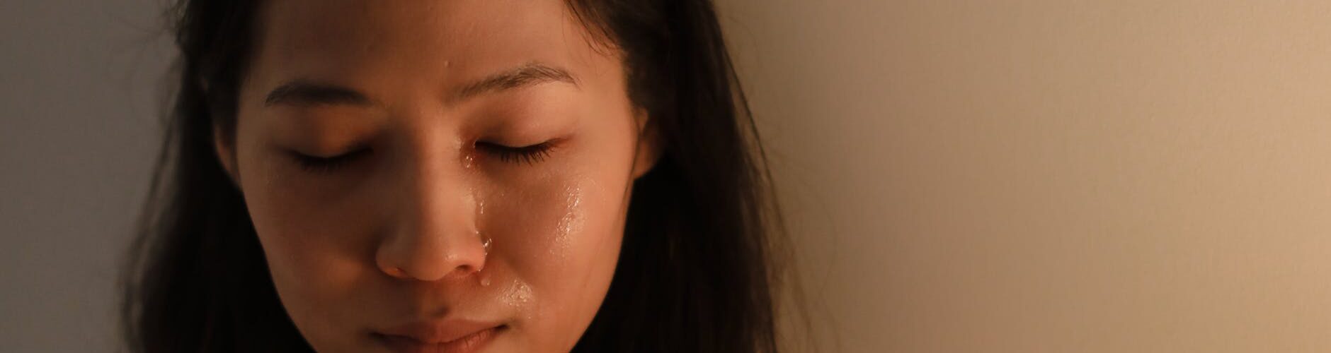 a crying woman with her eyes closed