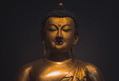 brass buddha statue in close up shot