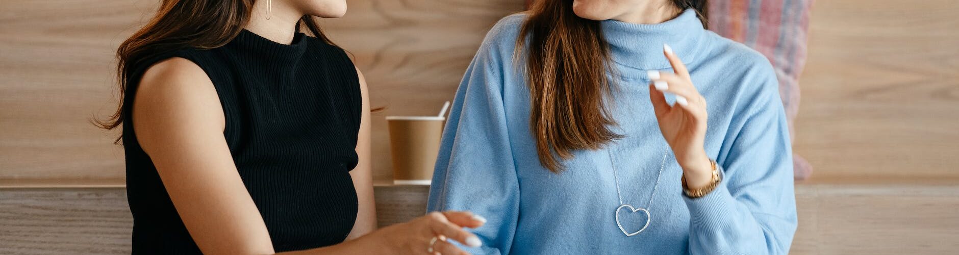 multiracial businesswomen with laptop talking about work