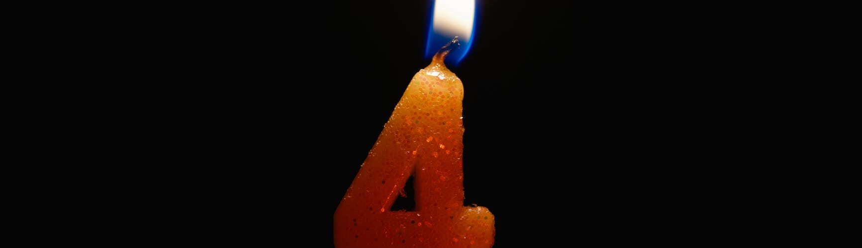 a lighted number candle on a black background