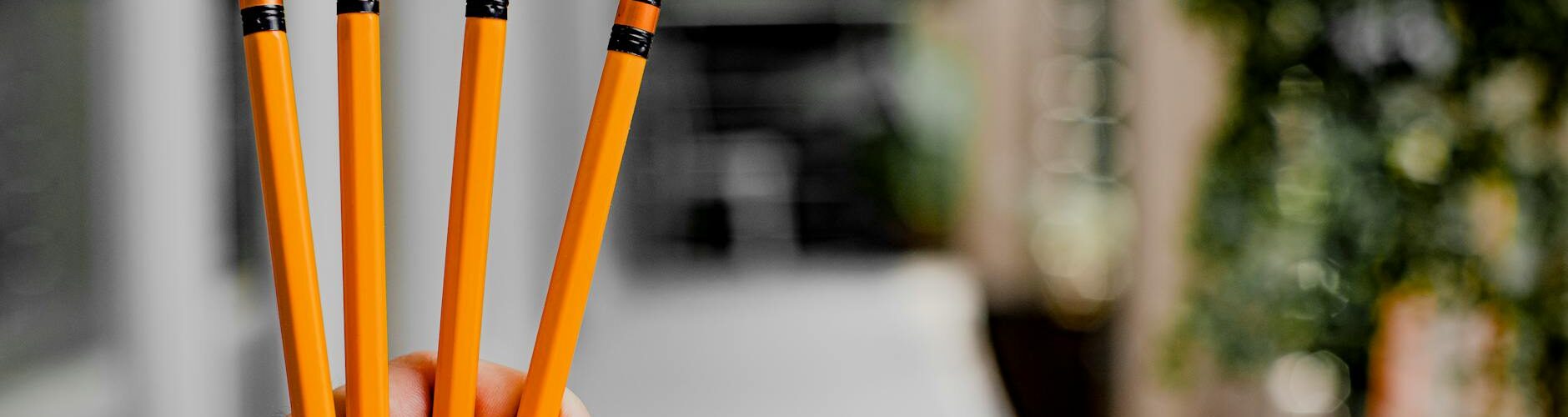 person holding pencils