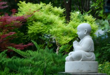 stone statue of buddha in a garden