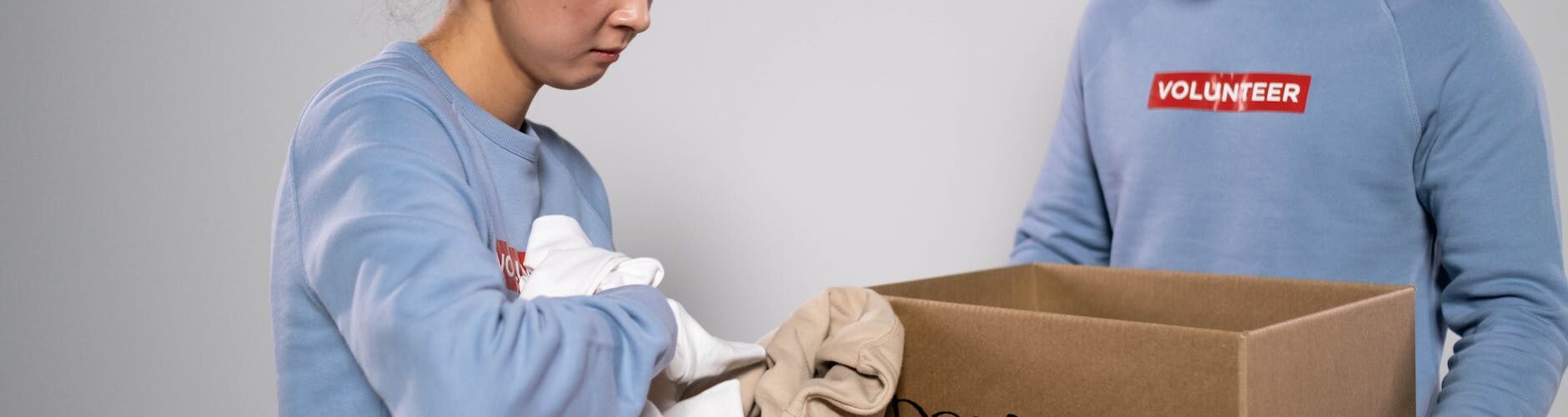 woman holding clothes for donations