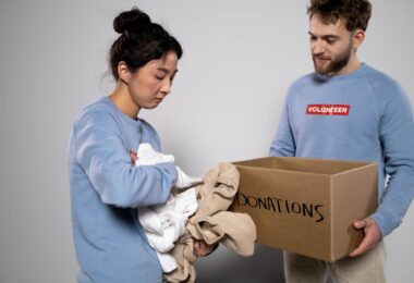 woman holding clothes for donations