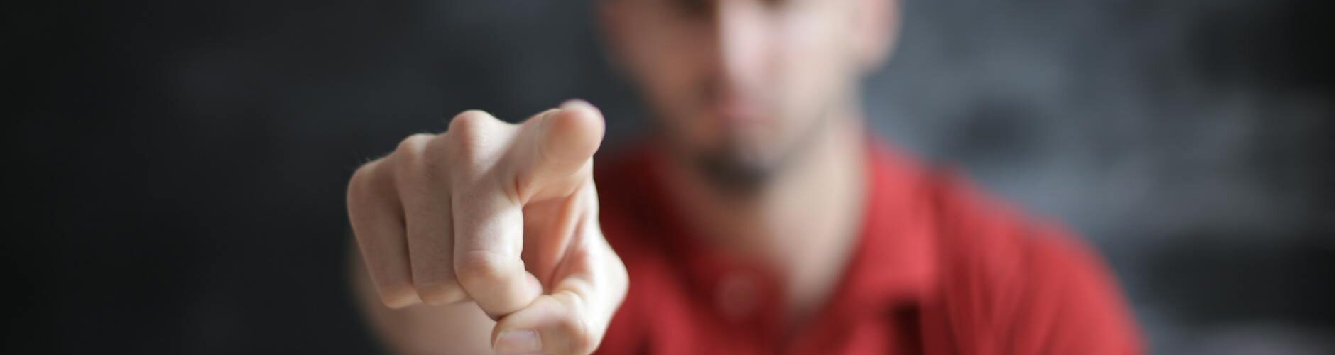 selective focus photo of man s index finger