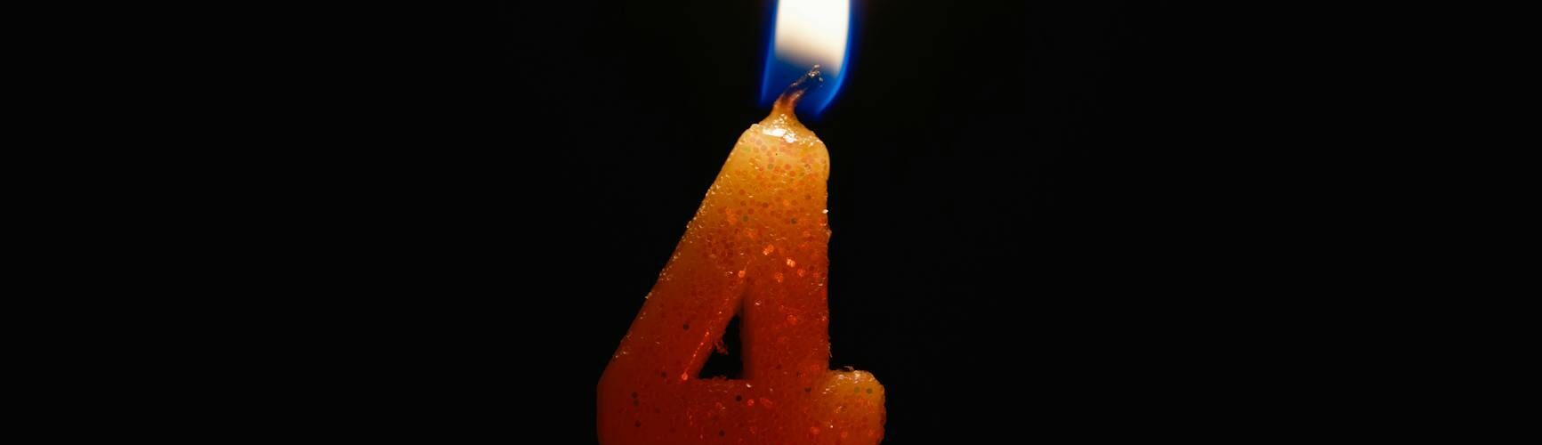 a lighted number candle on a black background