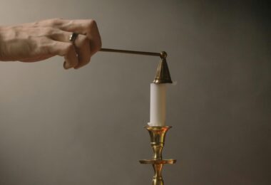 a person putting out a candle fire