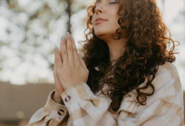 woman praying with hands clasped
