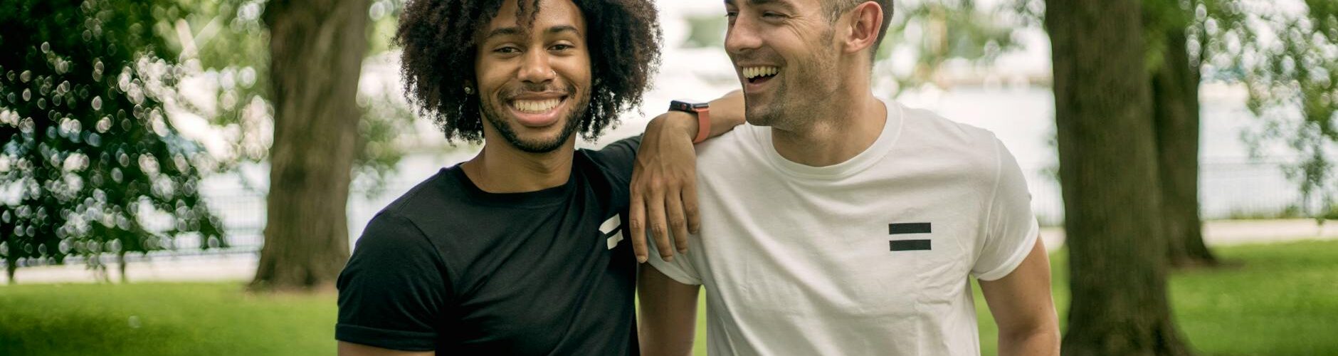 two men standing on grass field
