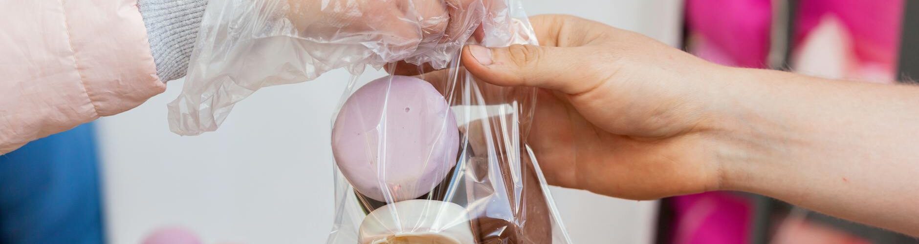 photo of a person getting a plastic with cookies