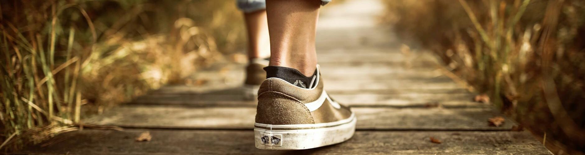 person stands on brown pathway
