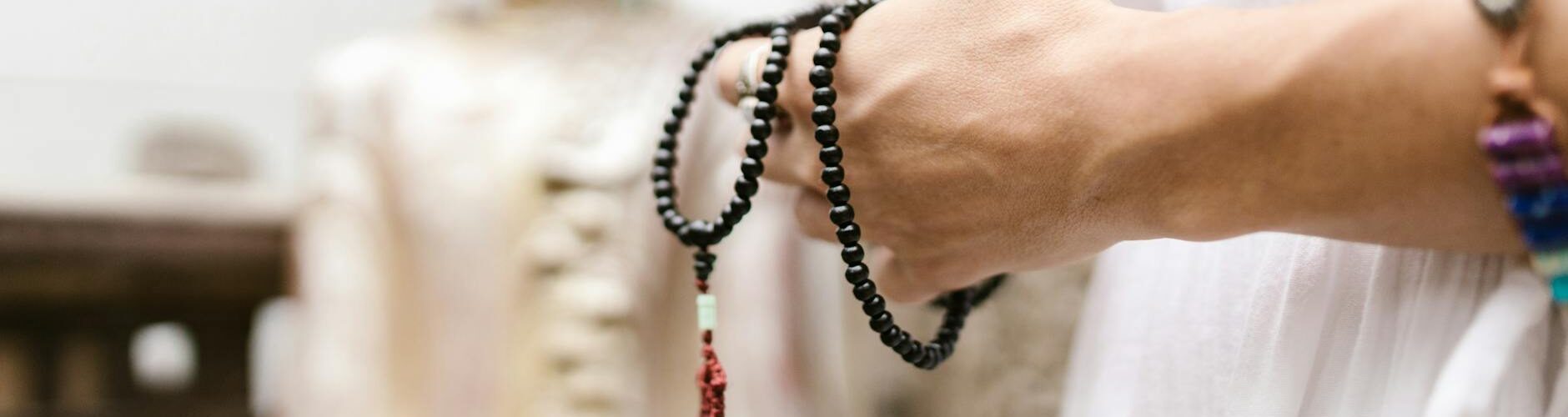 black loop of prayer beads in hands
