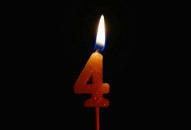 a lighted number candle on a black background