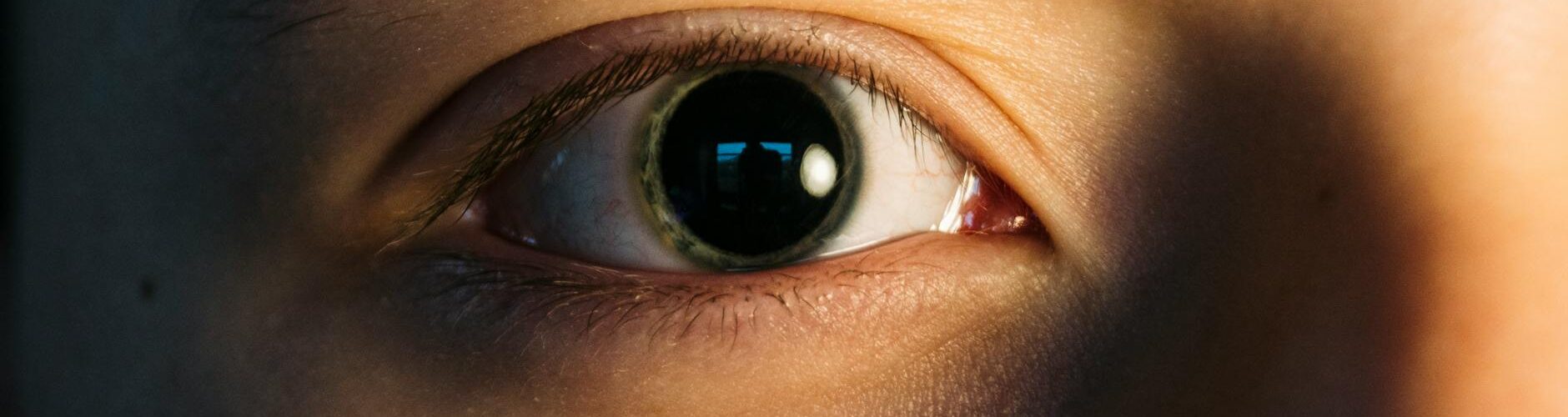 person s eye in close up photography