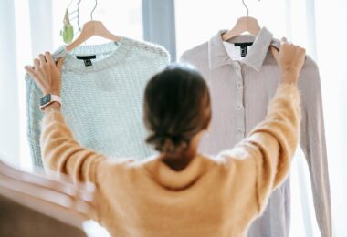 unrecognizable woman demonstrating clothes in store