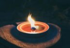 candle on wooden platform