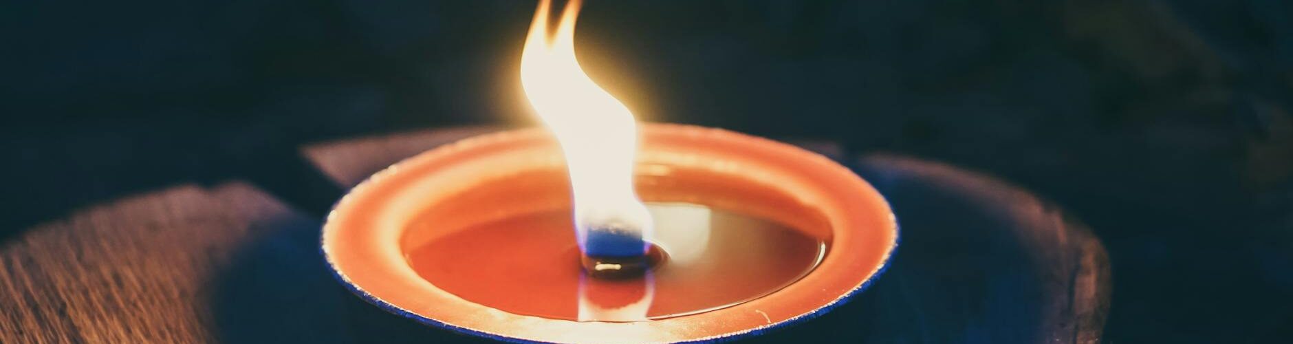 candle on wooden platform