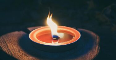 candle on wooden platform